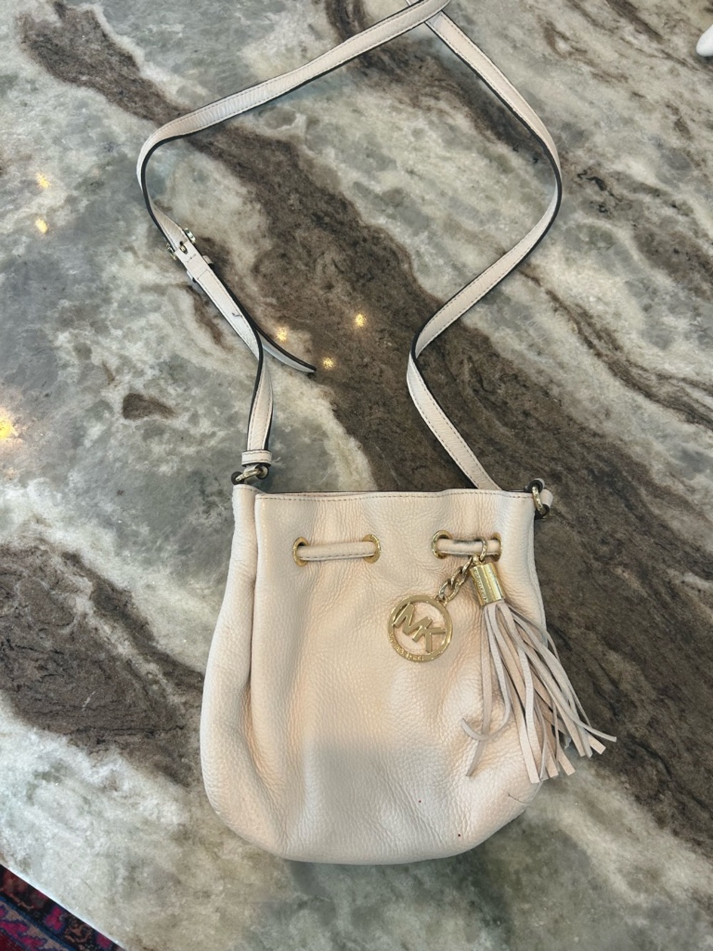 Michael Kors Pebbled Drawstring Crossbody has interior exterior stains wear